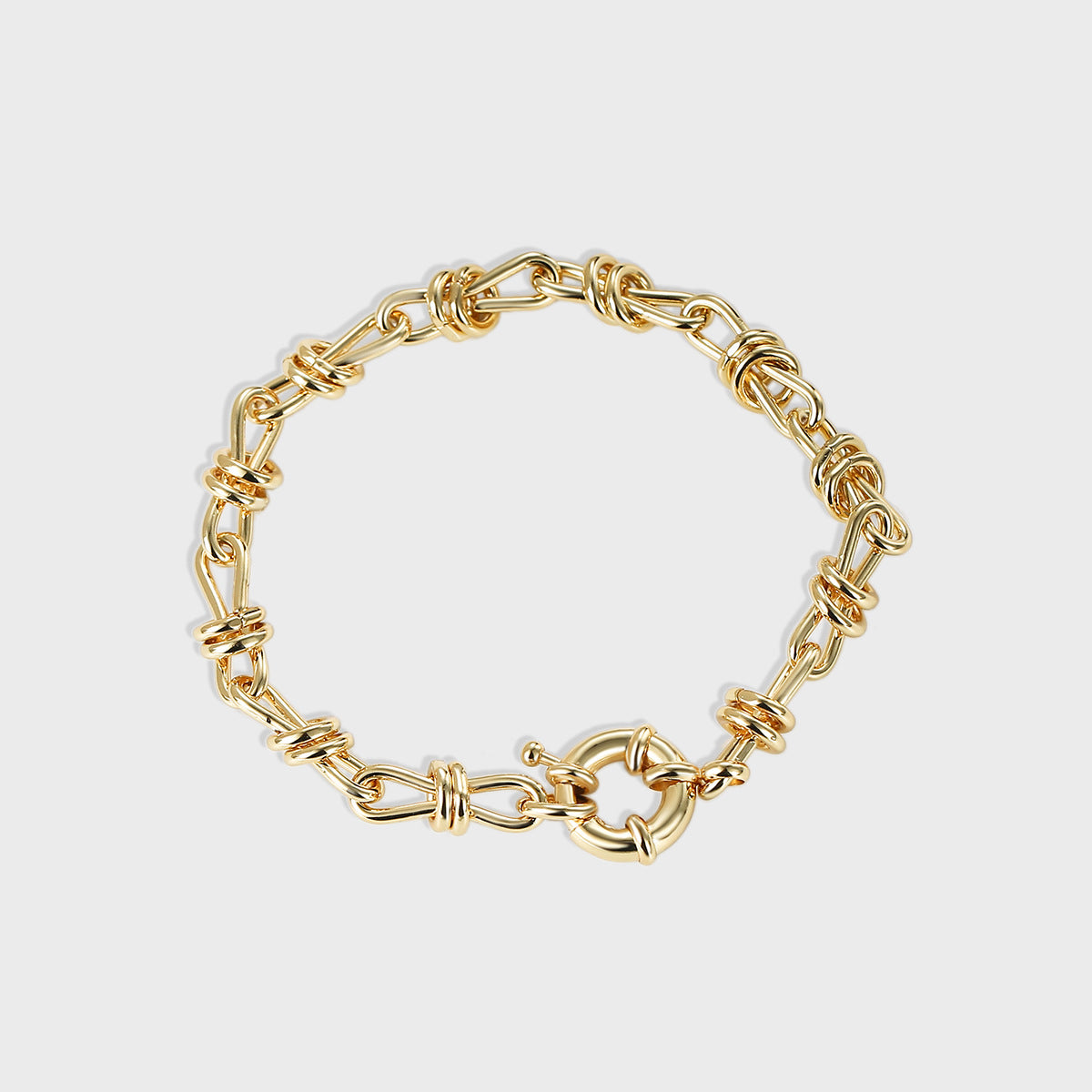 isolated gold plated brass chain bracelet with bow-knot link wraps