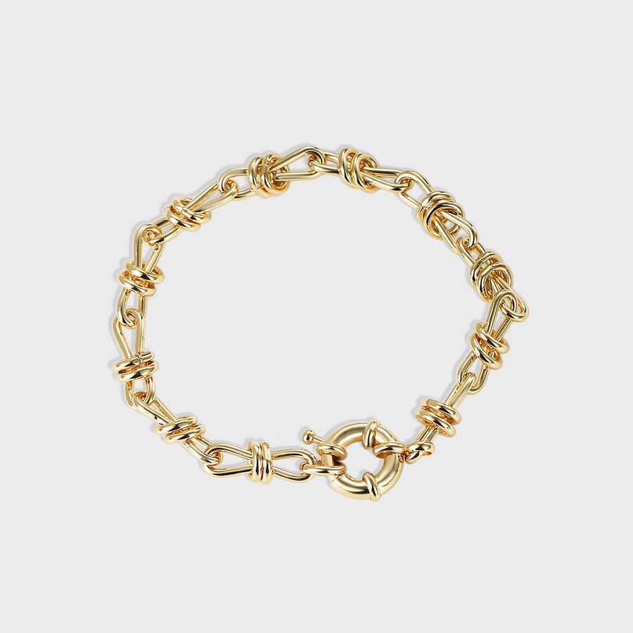 isolated gold plated brass chain bracelet with bow-knot link wraps