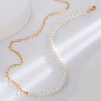 paperclip and pearl-style necklace arranged on a white display