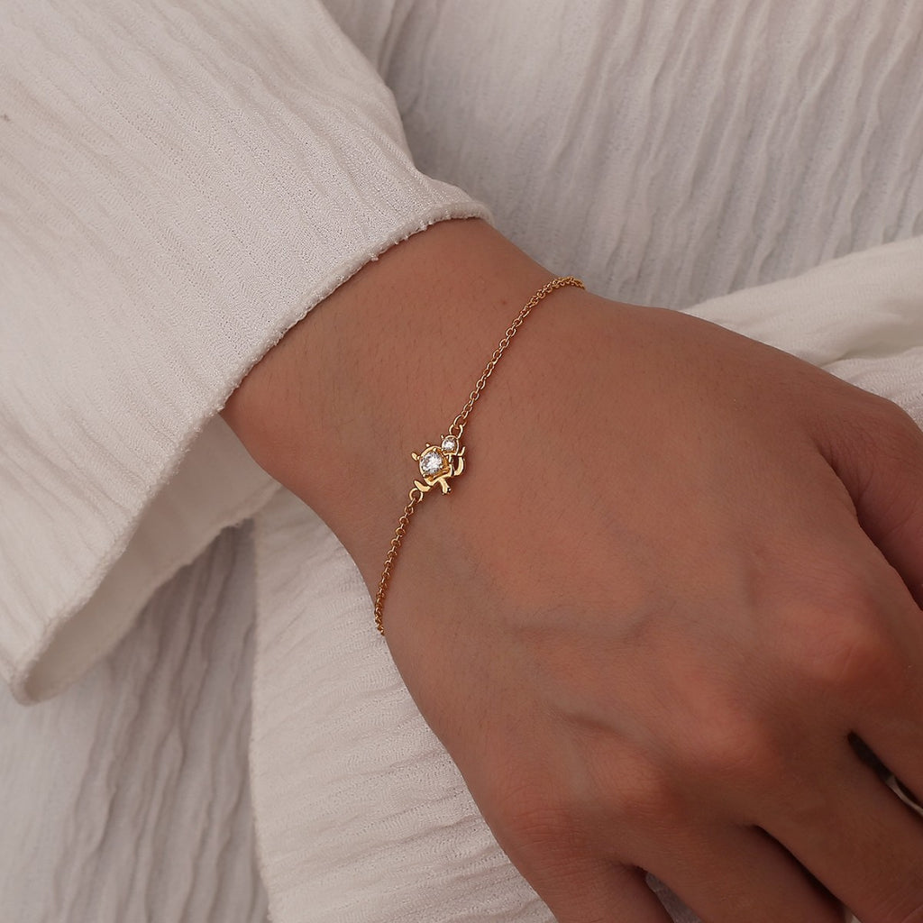 model wearing a fine gold plated turtle chain bracelet