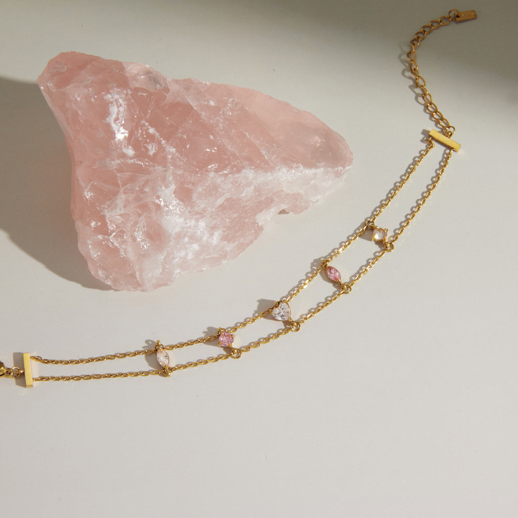 Double-chain bracelet with pink and clear stones laid flat