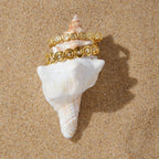 Two spiral cuffs styled around a shell