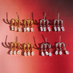 Gold-tone and silver-tone triple-hoop stud designs on red