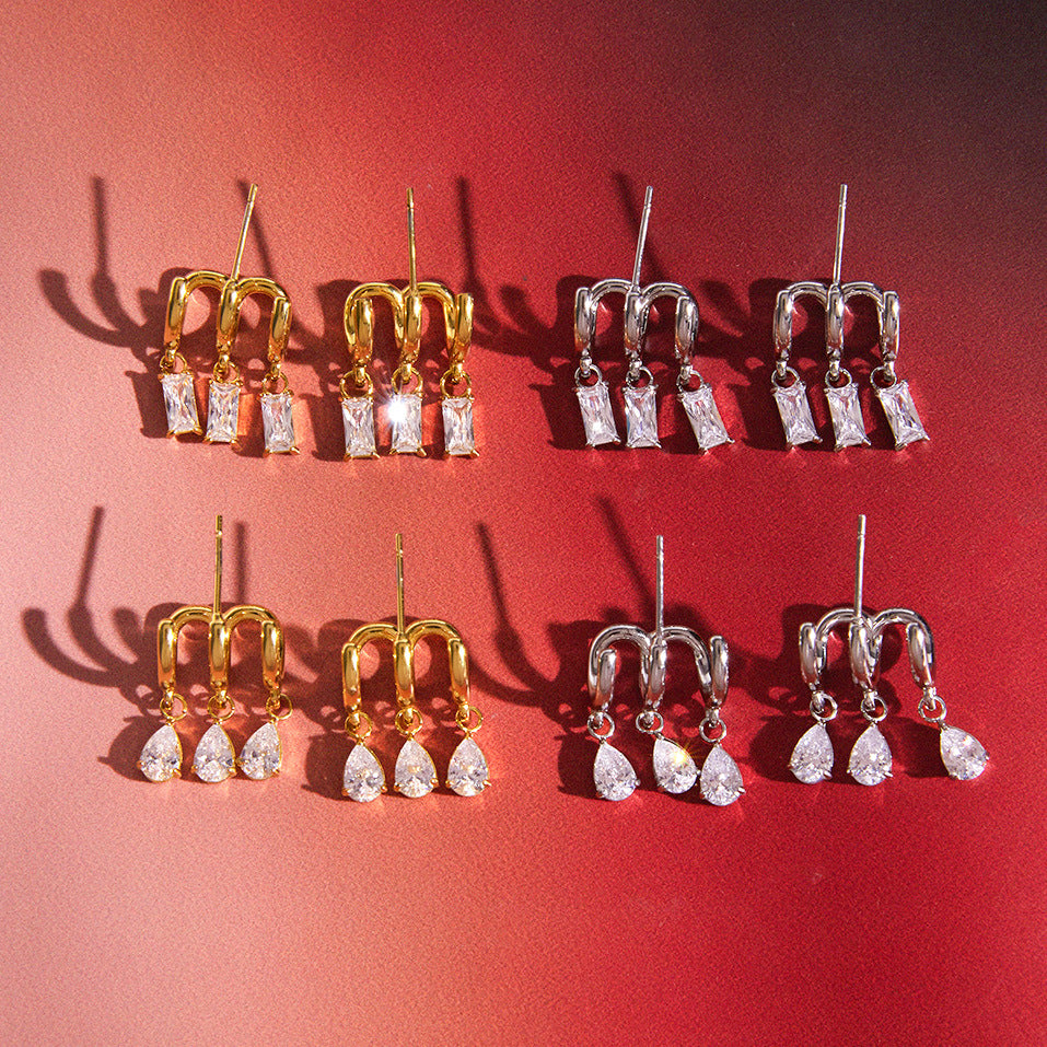 Gold-tone and silver-tone triple-hoop stud designs on red