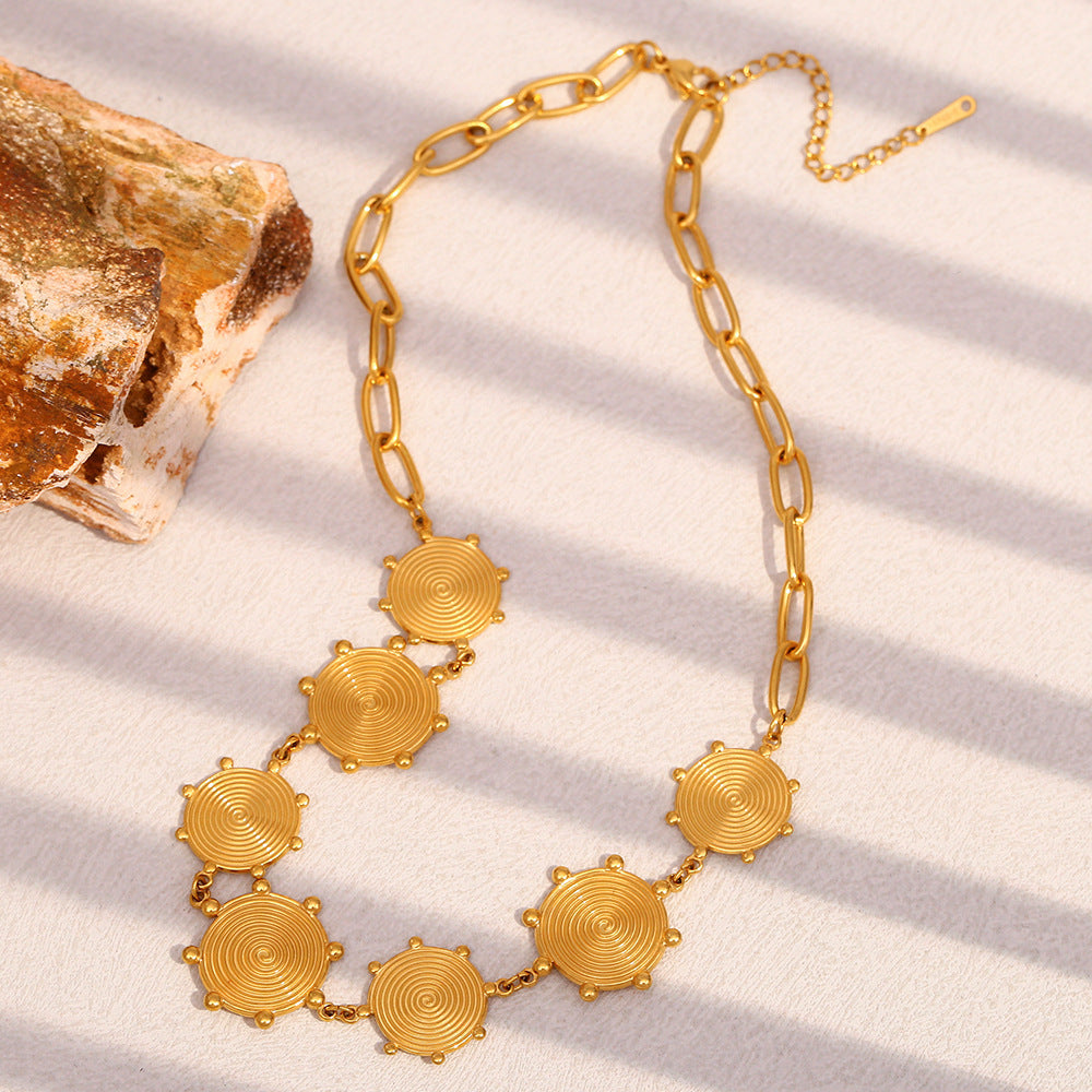 Gold Plated Stainless Steel Spiral Disc Station Necklace — disc texture close-up