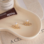 Gold-tone pearl stud earrings styled pair