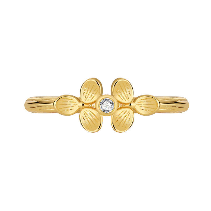 isolated gold plated clover clear stone ring on white