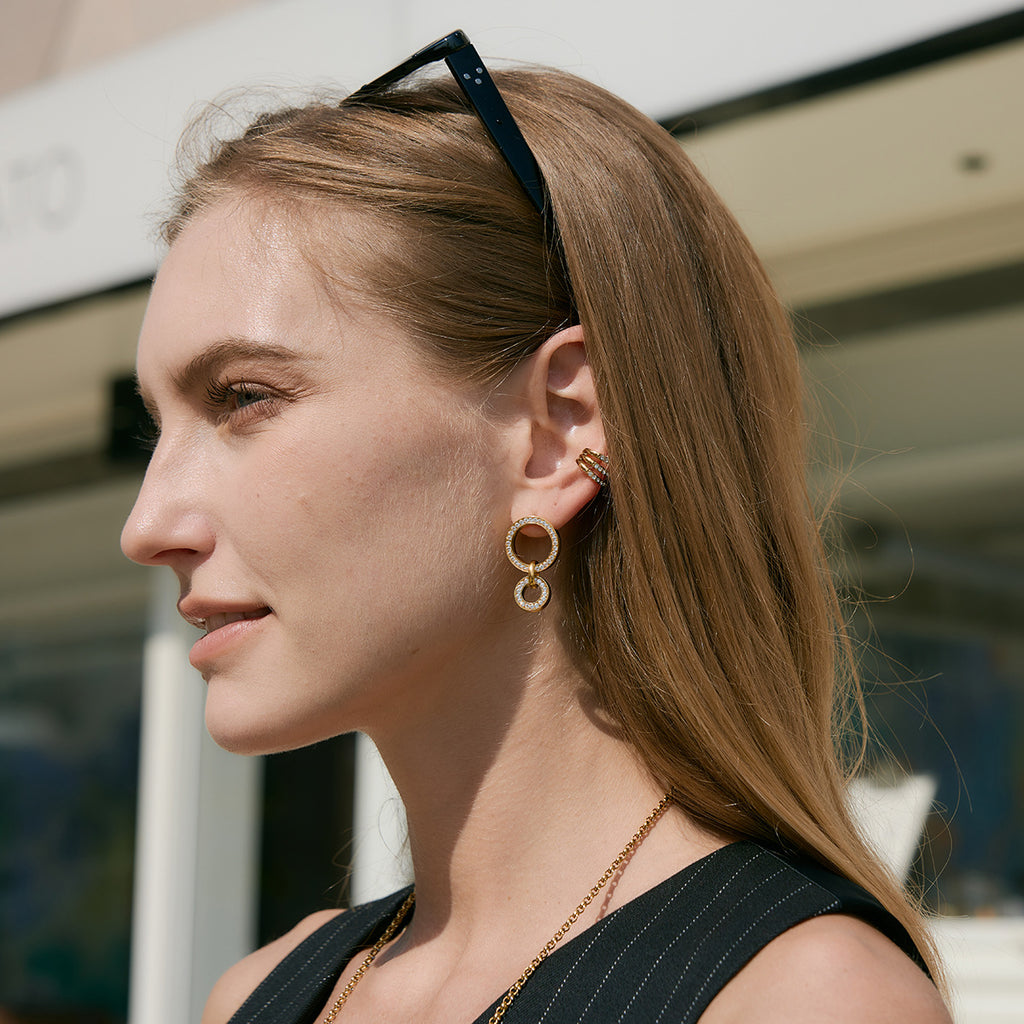 Circle-link earrings shown on model