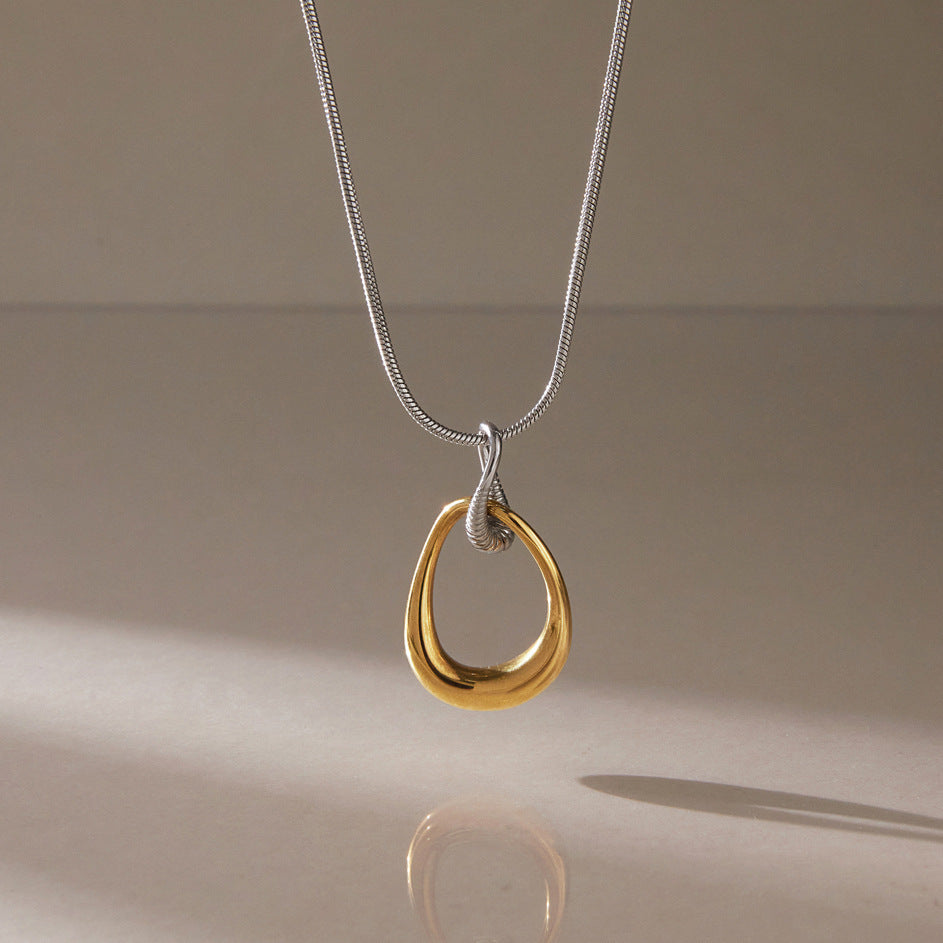 Gold-tone teardrop loop suspended from silver-tone chain
