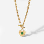 isolated chunky curb necklace with square green center stone