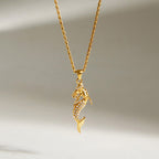 Gold-finish mermaid pendant with clear stones on a rope-style chain