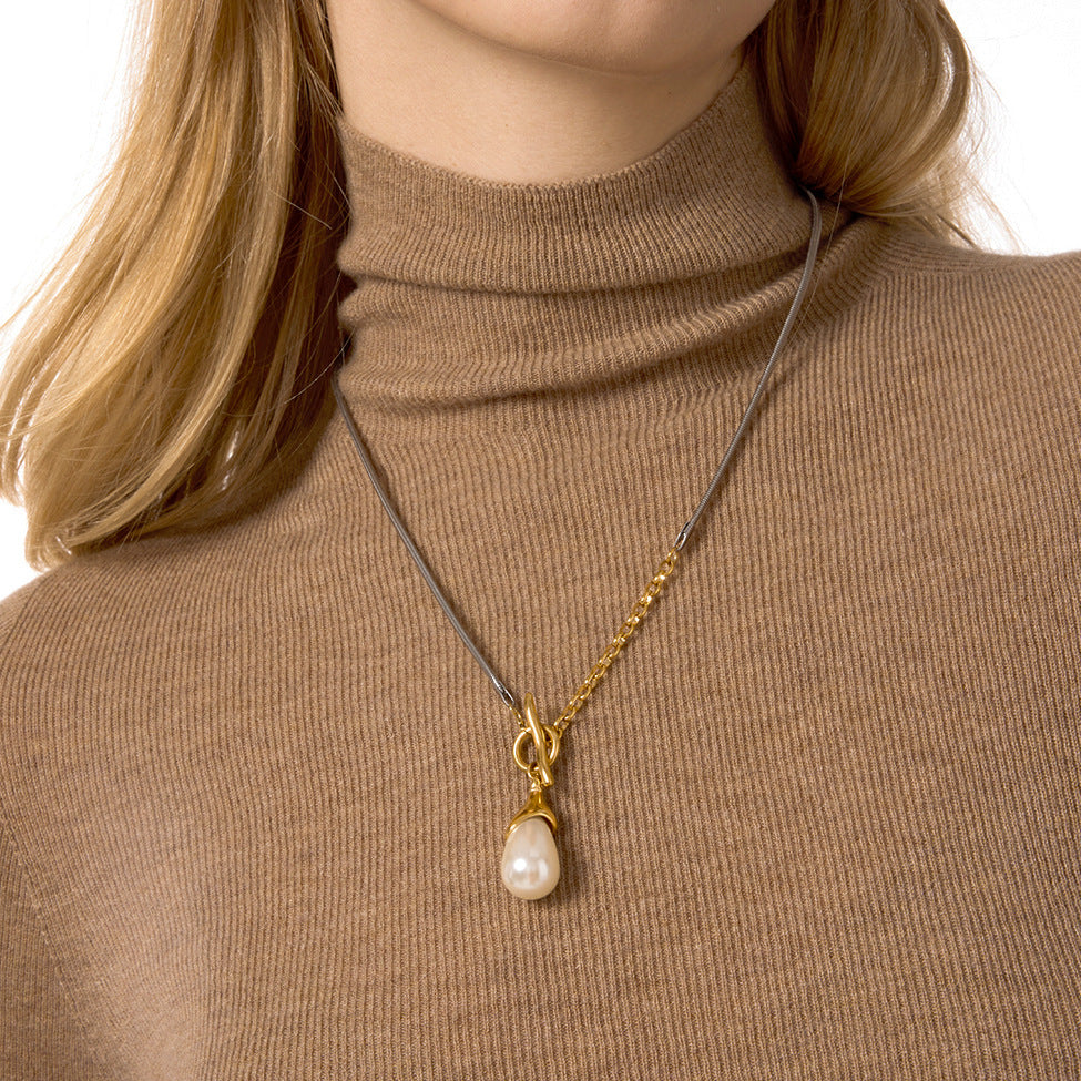 Silver-colored and gold-detail pendant necklace on a model