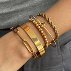 Close-up of a layered stainless steel bracelet selection