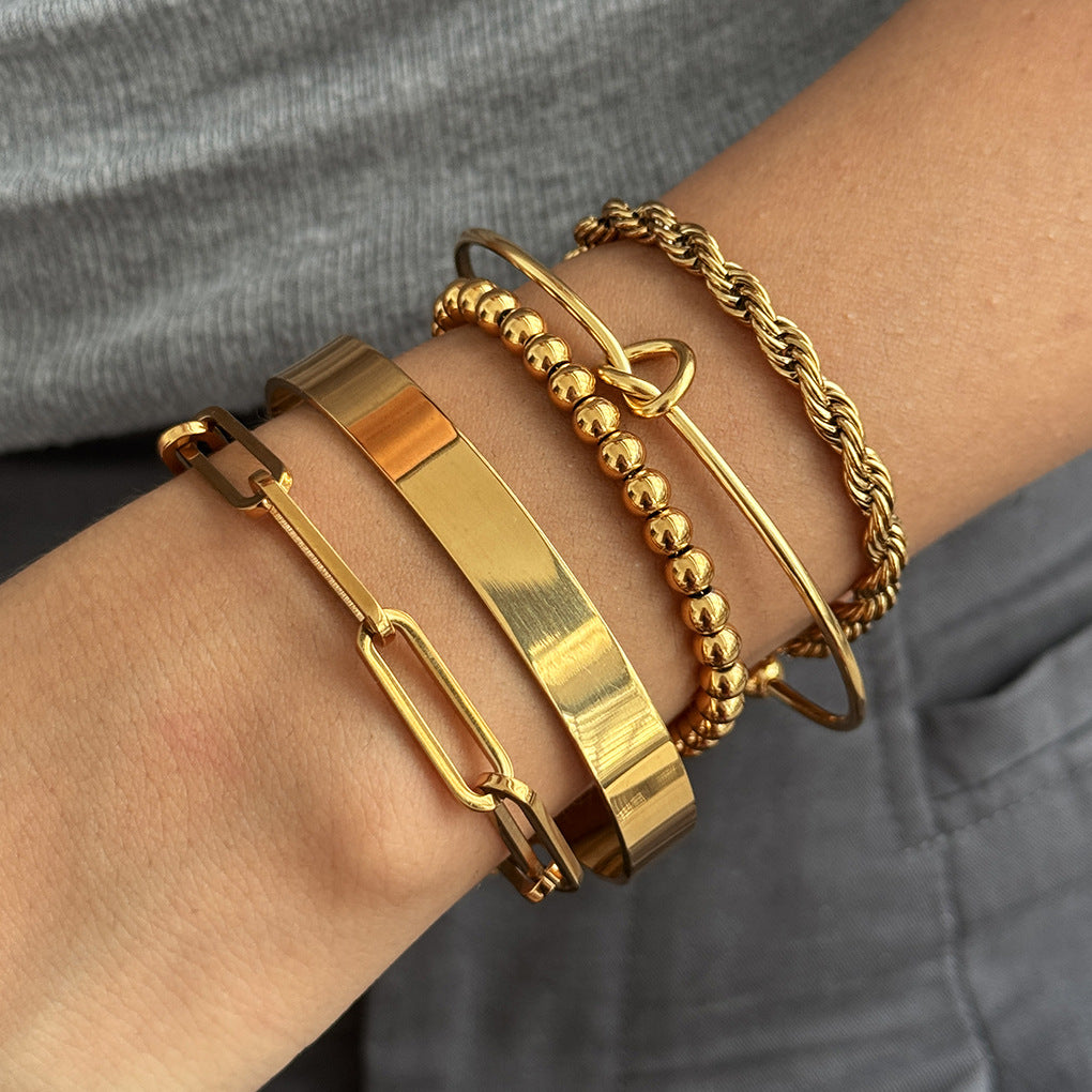 Close-up of a layered stainless steel bracelet selection