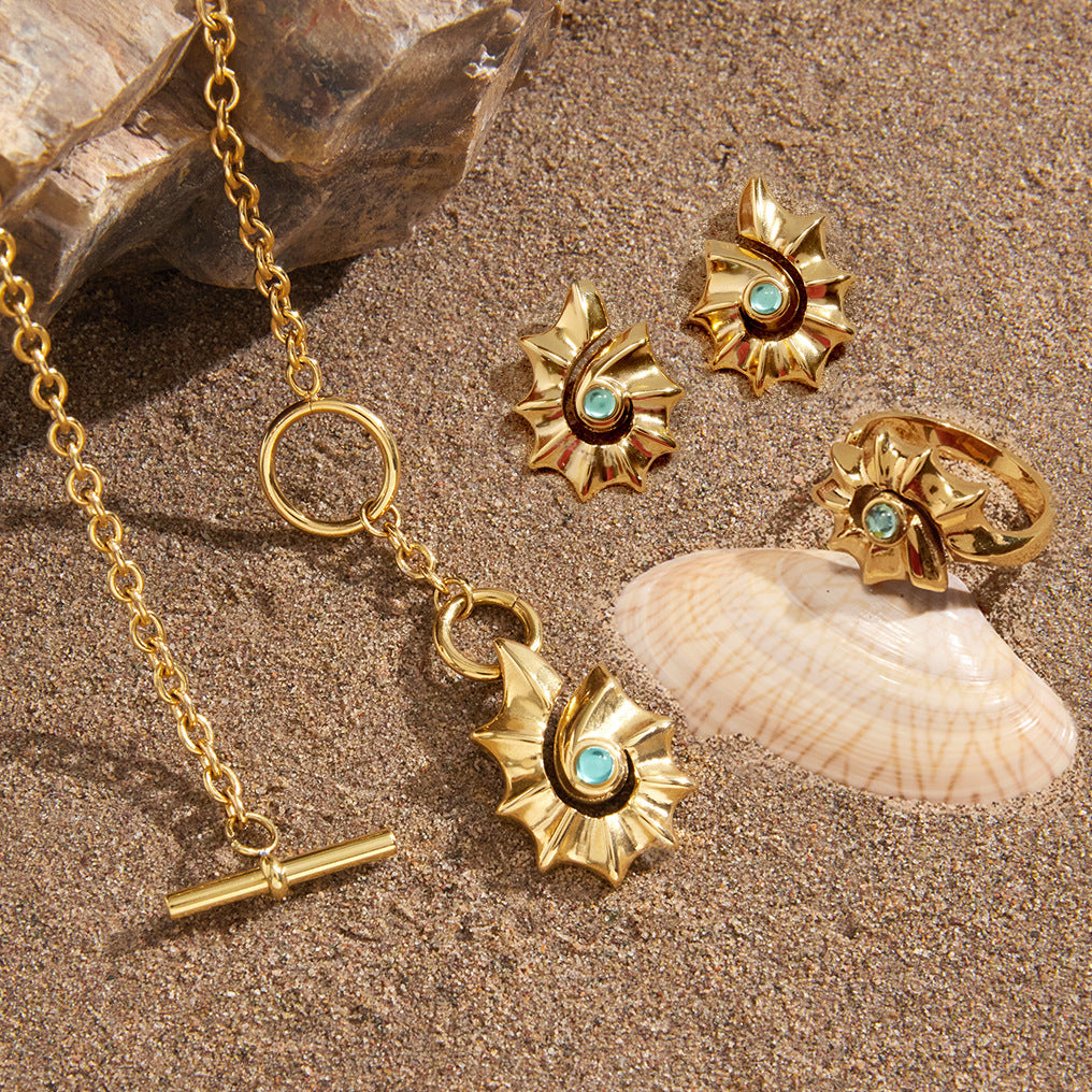 Shell pendant and coordinating jewelry on sand