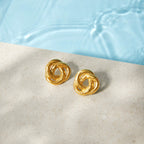 Gold-tone knot studs beside a pool