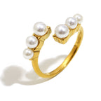 cutout of slim stainless steel open ring with pearl clusters