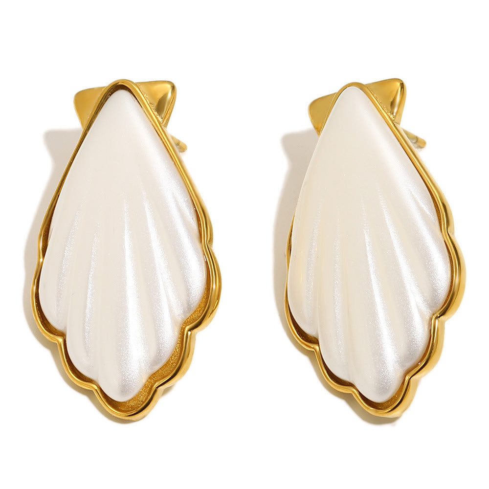 gold plated white shell-shaped acrylic stud earrings on white
