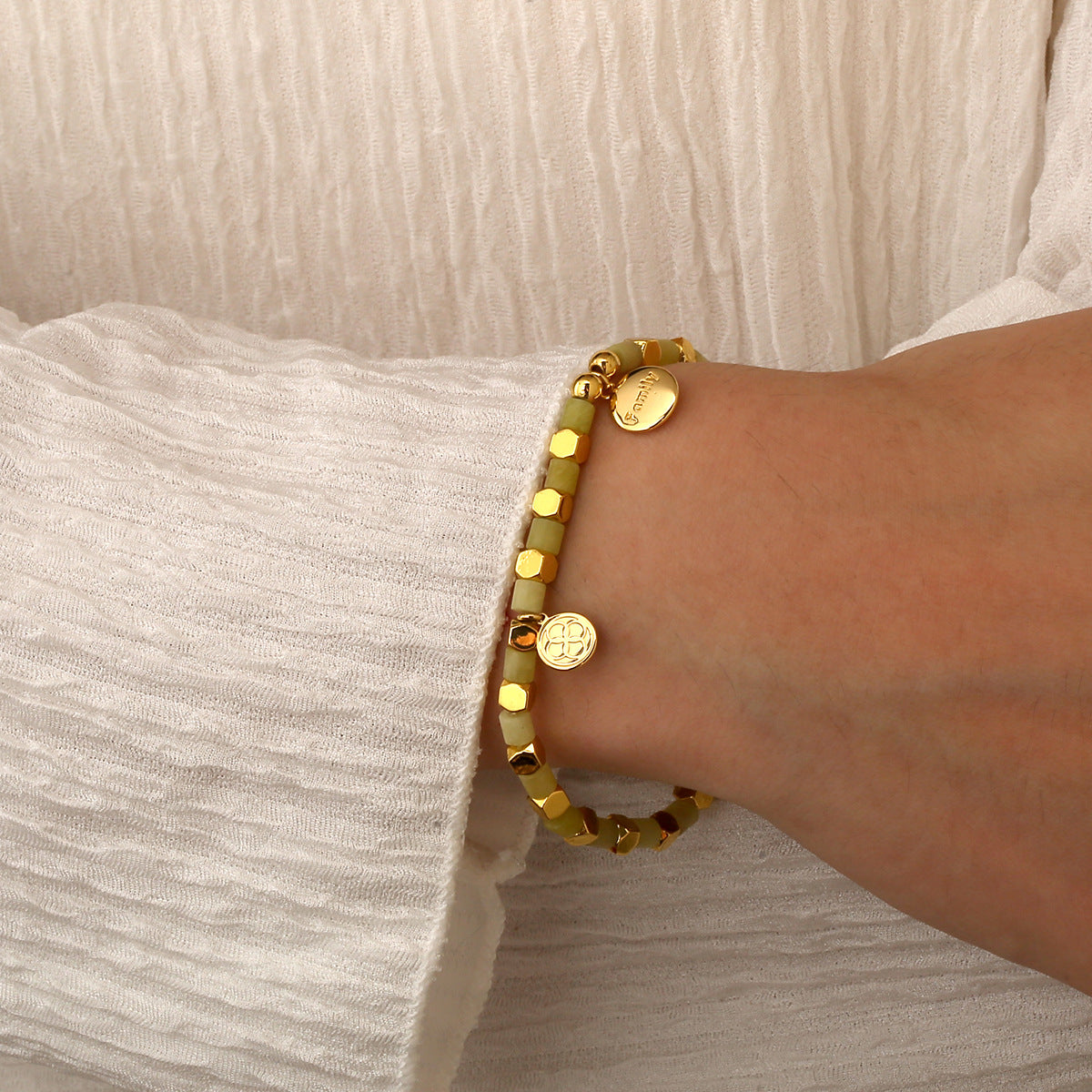 model wearing the gold plated Family message bracelet
