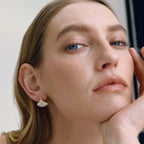 Gold-tone fan earring shown on model