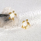 Gold plated opal sea turtle stud earrings styled on stone