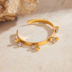 Side view of stainless steel ball fringe cuff on stone props
