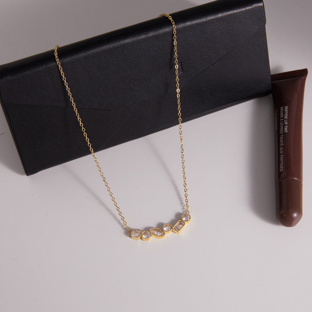 Cluster necklace displayed on a black accessory