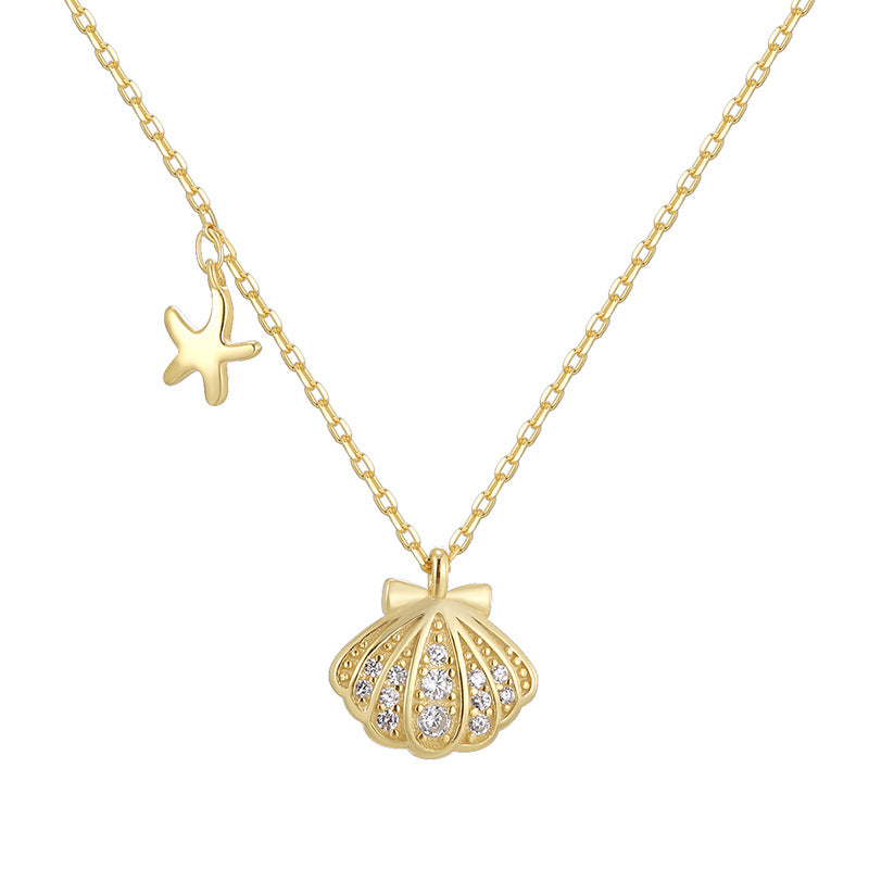 angled isolated view of ribbed seashell pendant and starfish charm