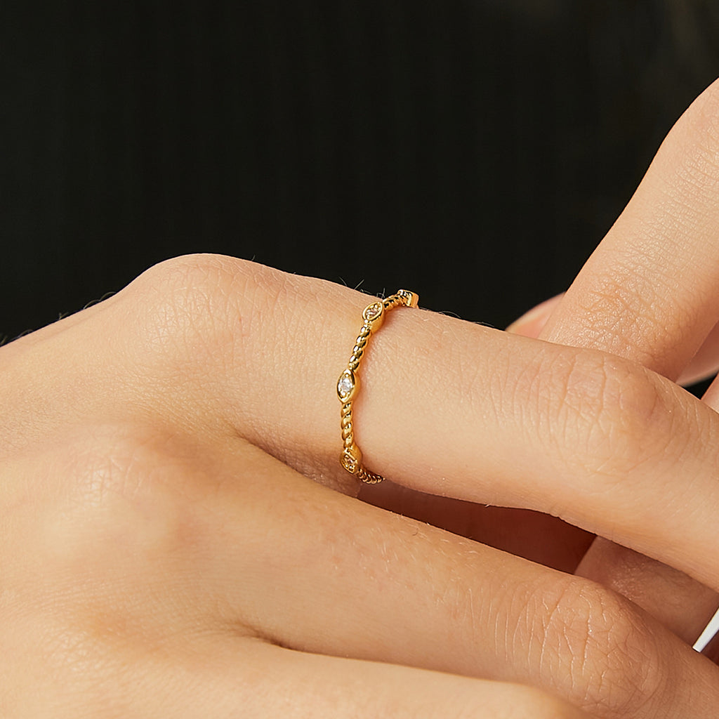 delicate rope-texture clear stone ring worn on a finger