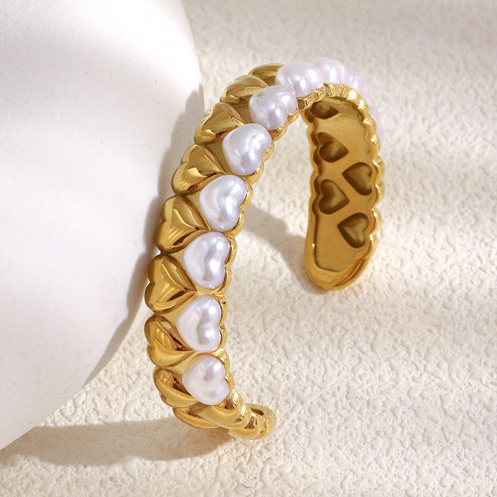 side view showing white imitation-pearl hearts and cutout metal motifs