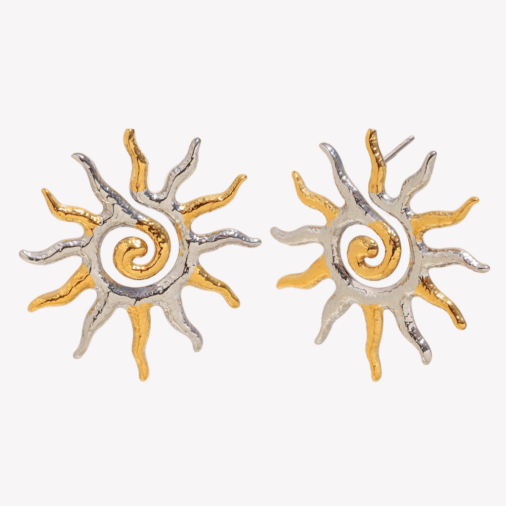 two-tone spiral sunburst stud earrings isolated on white