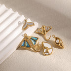 Shell, ray and whale-tail charms on stone