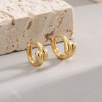 front and side studio view of gold plated triple-lobe hoops