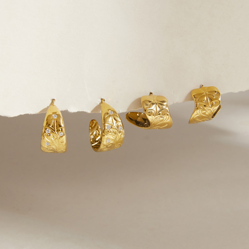 Two gold tone scroll pattern hoop earring styles