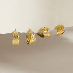 Two gold tone scroll pattern hoop earring styles