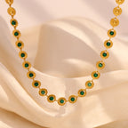 gold plated medallion link necklace with green center stones