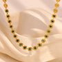 gold plated medallion link necklace with green center stones