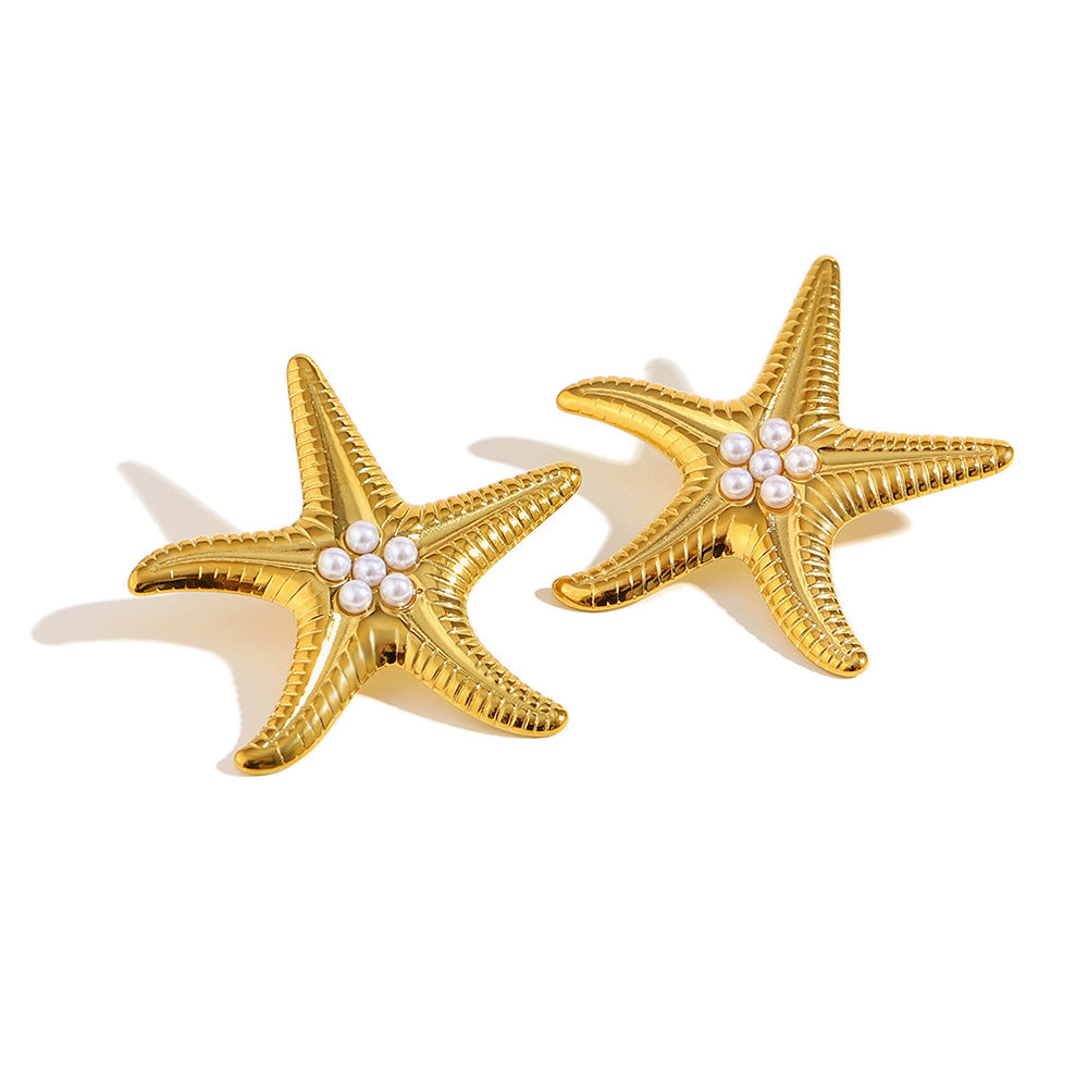 gold plated starfish earrings with clustered imitation pearls on white