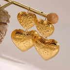 Gold-Tone Embossed Double Heart Stainless Steel Drop Earrings close-up product view