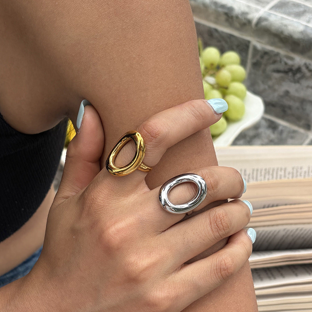 Gold and steel color open oval rings worn together