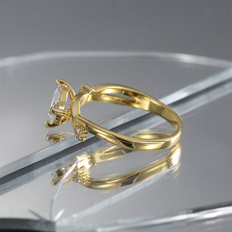 side profile of diagonal clear stone setting on polished brass band