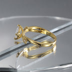 side profile of diagonal clear stone setting on polished brass band