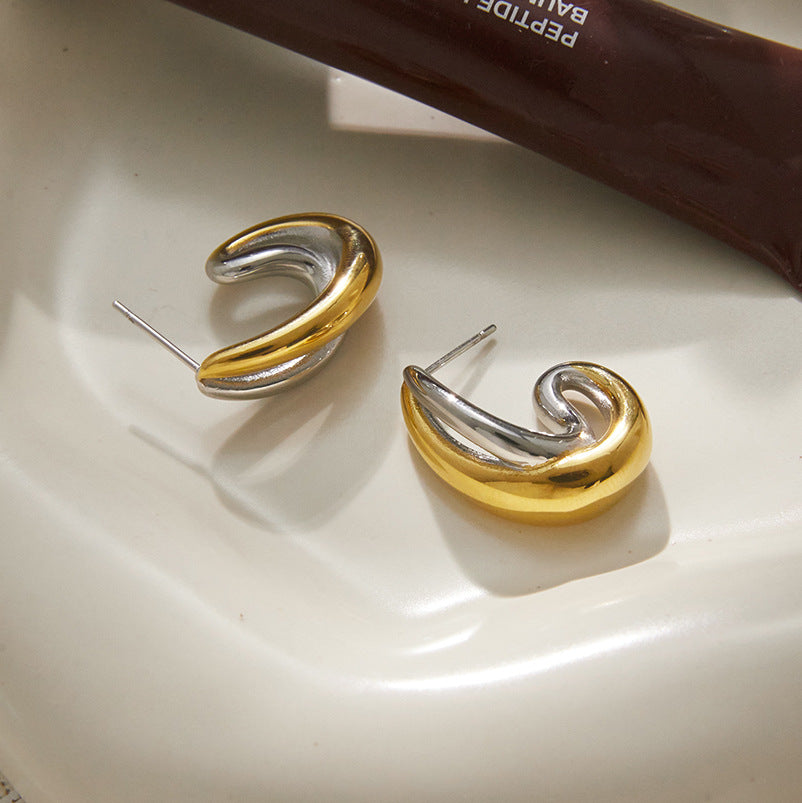 Overlapping gold and silver tone curves with stud posts