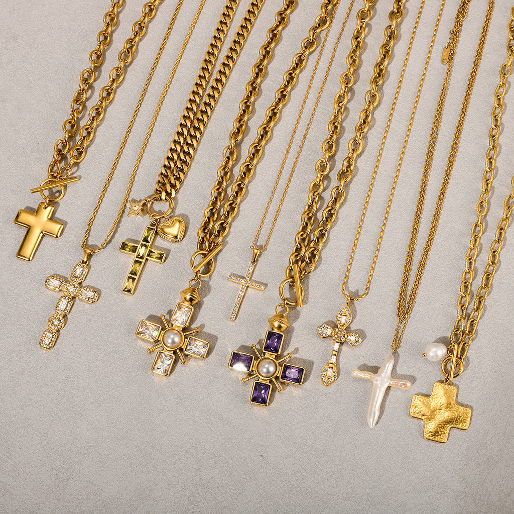 Gold-tone cross necklaces displayed with different chains and pendant settings