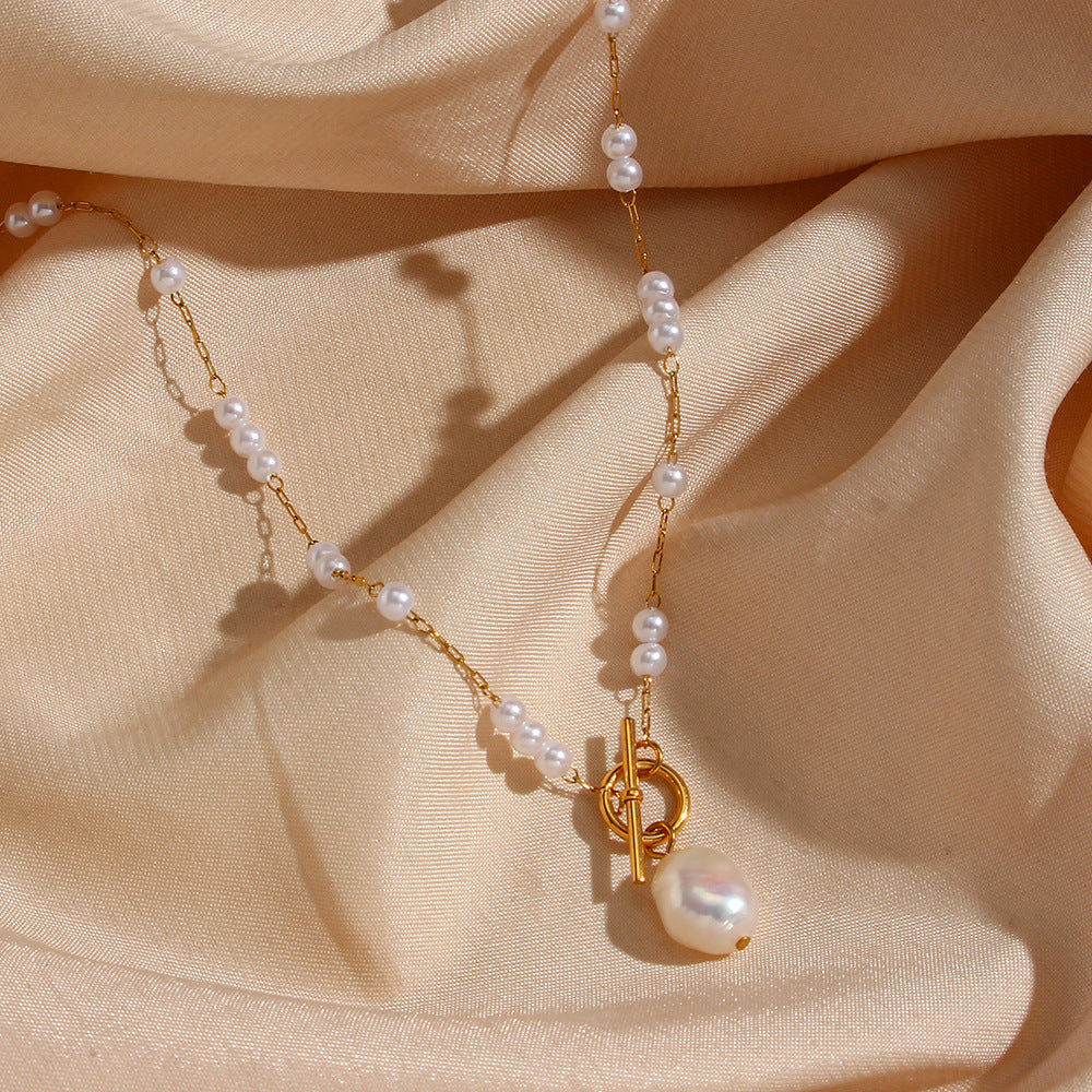 bar-and-ring toggle with oversized irregular white drop on satin