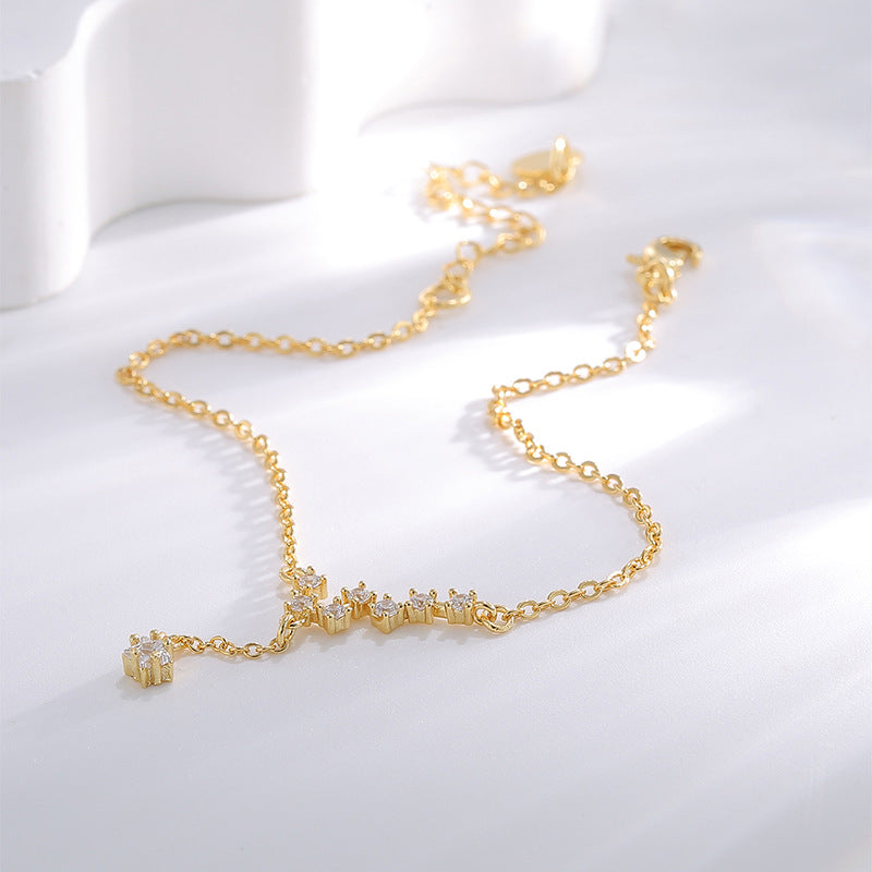 gold plated celestial anklet with staggered zirconia star line