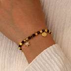 model wearing the gold plated brown bead sunburst bracelet