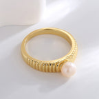 side view of gold plated ring with raised white shell pearl
