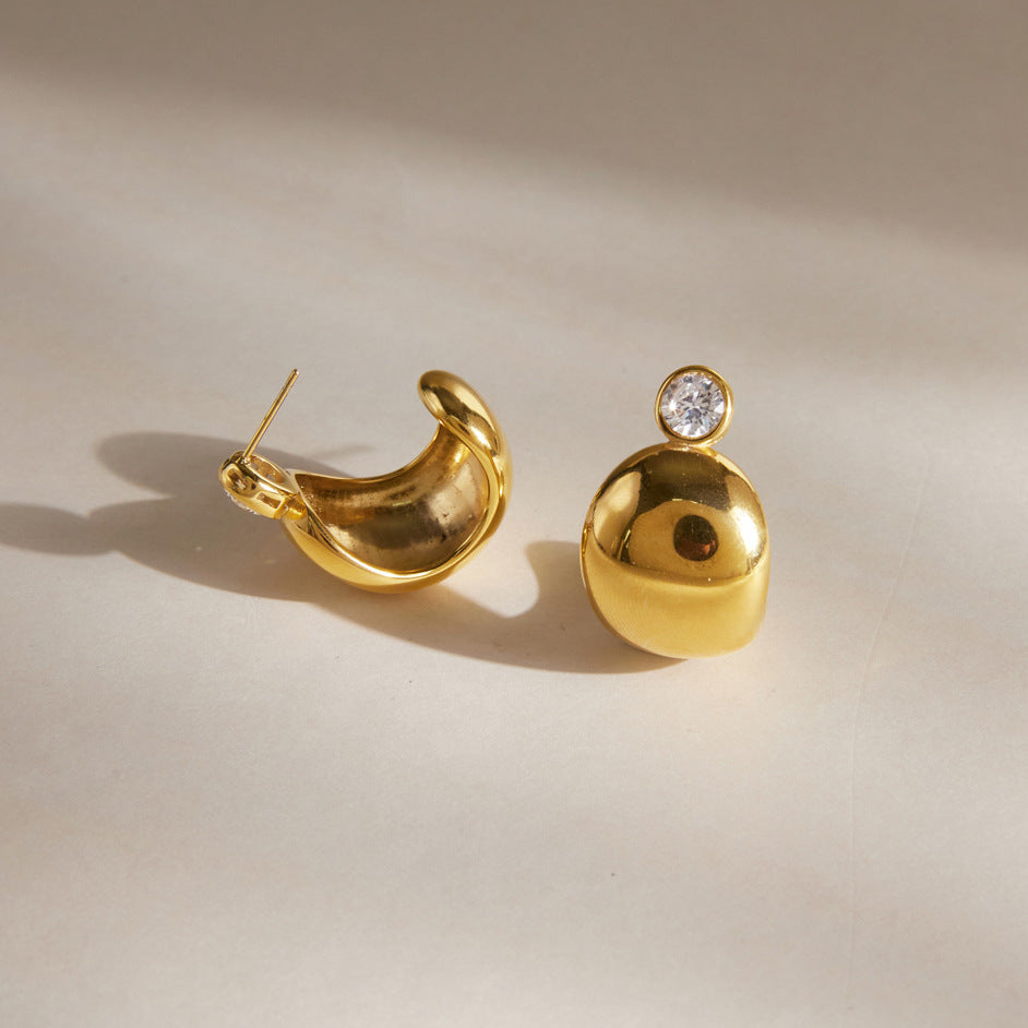 Round zirconia studs with domed gold tone bodies and visible backs
