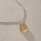 Pendant necklace arranged on a textured surface